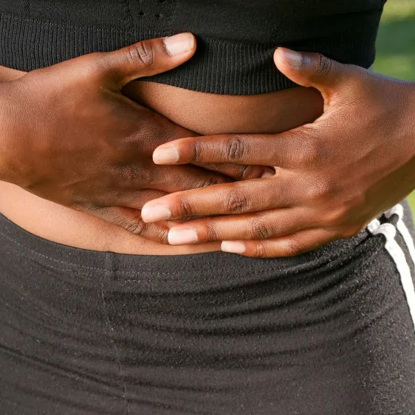 Woman holding abdomen experiencing pelvic pain